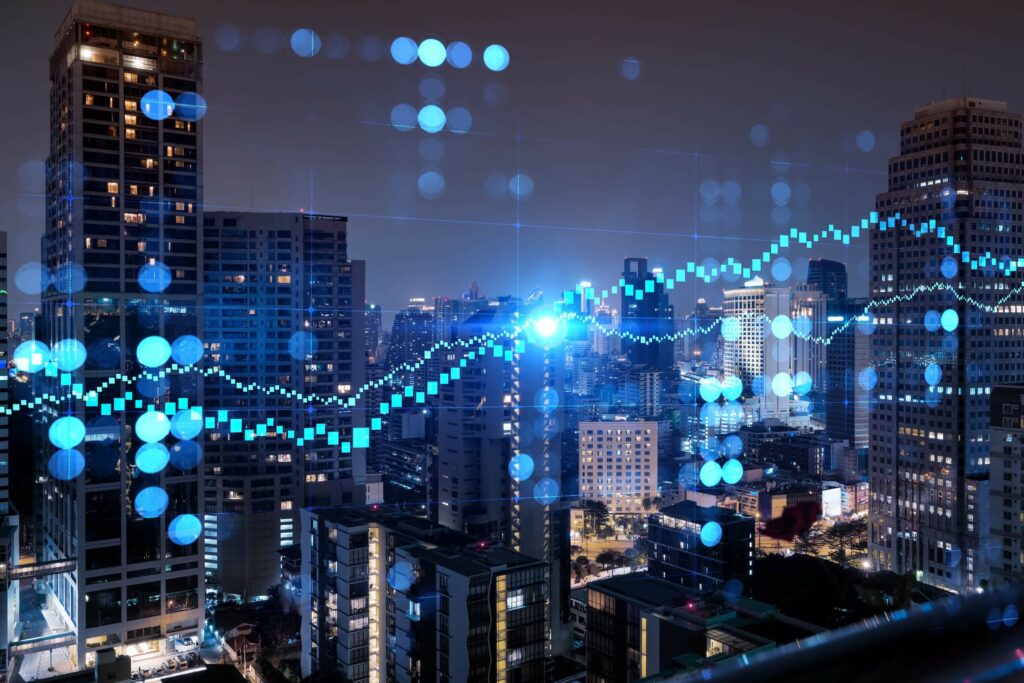 aerial night panoramic cityscape and FOREX graph hologram as the concept of market analysis