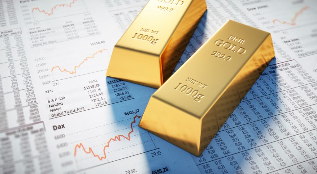 investing in gold: gold bars on stock market newspaper