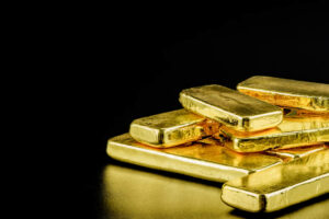 pure gold bars on black background compressed